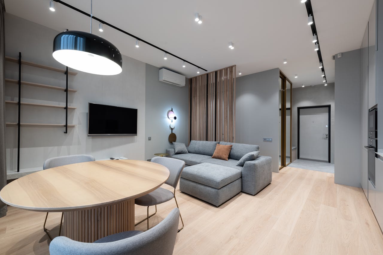 services-03 Design of comfortable studio apartment with grey walls placed near wooden table and chairs