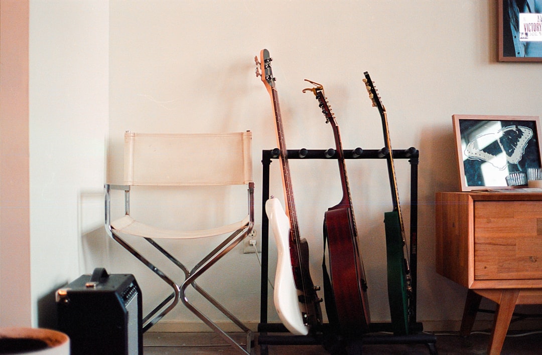 services-04 a-room-with-a-chair-and-a-rack-with-guitars-ddzgf5cve38