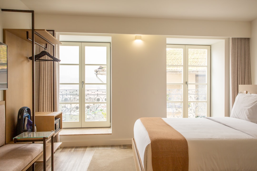 trusted-partner a-hotel-room-with-a-large-bed-and-a-window-qbhf5gozhvu