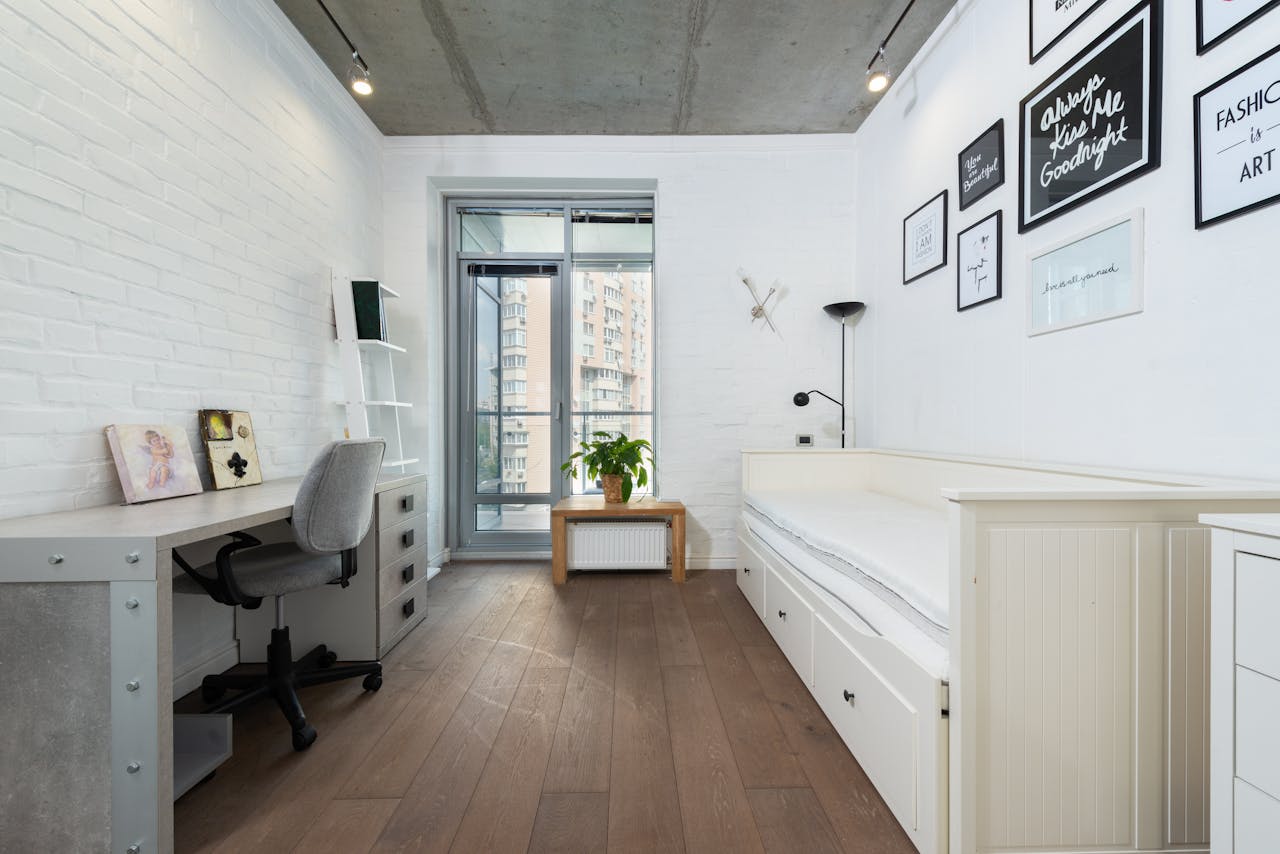 home-img Bright, minimalist bedroom with contemporary decor and stylish furnishings.